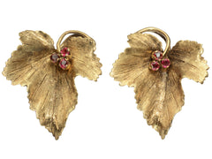 thumbnail of Pair of grape leaf shaped earrings in 18K yellow gold with ruby centers, shown on white background.