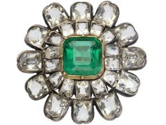 thumbnail of A 19th century silver and gold brooch with a green crystal surrounded by petals of clear white faceted crystals, shown on white background.