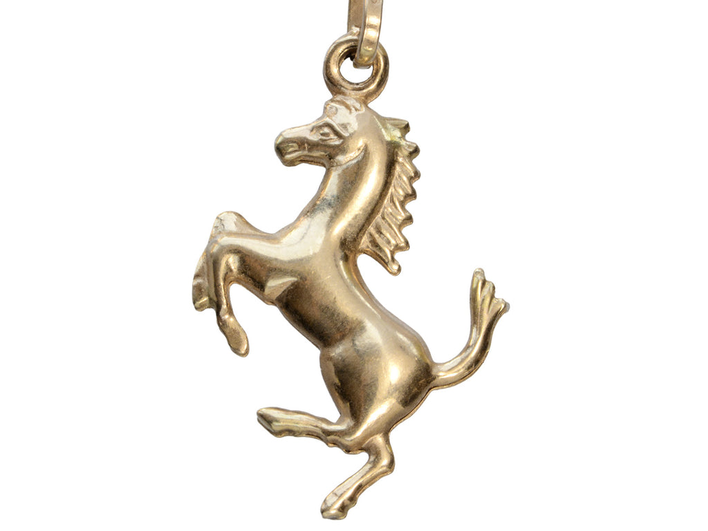 Gold horse pendant on a white background