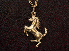 thumbnail of Gold horse pendant necklace on a dark textured background. "ITALY" stamp visible on bale.