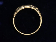 thumbnail of Side profile of vintage gold ring with pair of running horses, shown on dark background.