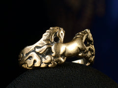 thumbnail of Vintage gold ring with pair of running horses, shown on dark background.