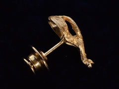 thumbnail of Side profile of vintage yellow gold tie tack in the form of a horse's ass. Showing pin back. On black background.