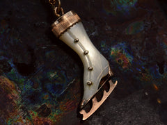 thumbnail of Front of antique ice skate pendant with mother of pearl and rosy gold fittings (on dark colorful background)