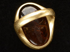thumbnail of Inside view of antique yellow gold signet ring with amber glass intaglio of classical scene (Eros fishing), shown on dark background.