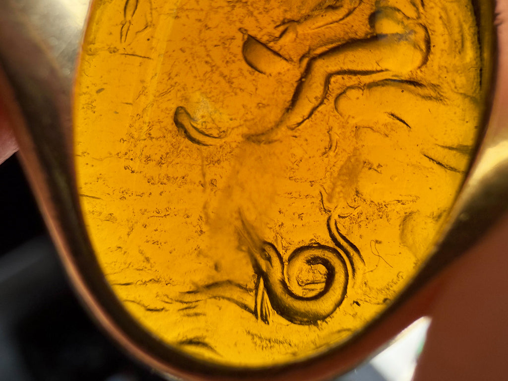 Close up reverse view of intaglio, showing detail of sea serpent.