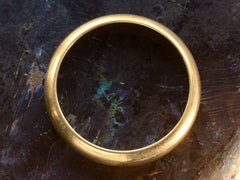 thumbnail of Side profile of a rounded vintage 4.7mm 18K Italian wedding band, shown on dark background.