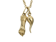thumbnail of A pair of vintage 18K yellow gold Italian charms: a figa and a cornicello hanging on a cable chain, shown on white background. A "750" stamp is visible on the bale.