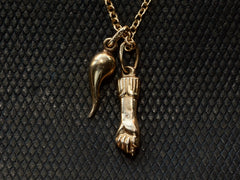 thumbnail of A pair of vintage 18K yellow gold Italian charms: a figa and a cornicello hanging on a cable chain, shown on dark textured background. A "750" stamp is visible on the bale.