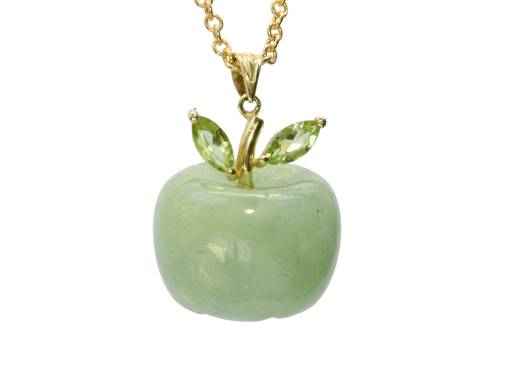 Light green apple shaped pendant carved from jade with a gold stem and peridot leaves, shown on white background.