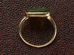thumbnail of Side profile of an antique signet ring with a dark green intaglio mounted in rosy-yellow gold and shown on dark textured background.
