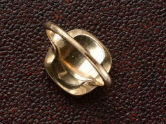thumbnail of Inside view of an antique signet ring in rosy-yellow gold and shown on dark textured background.