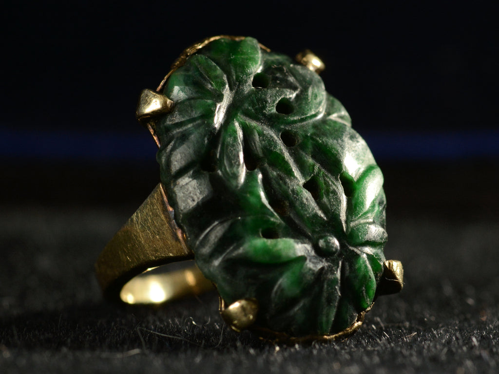 c1920 Carved Jade Ring in Yellow Gold (side angle view on dark background)