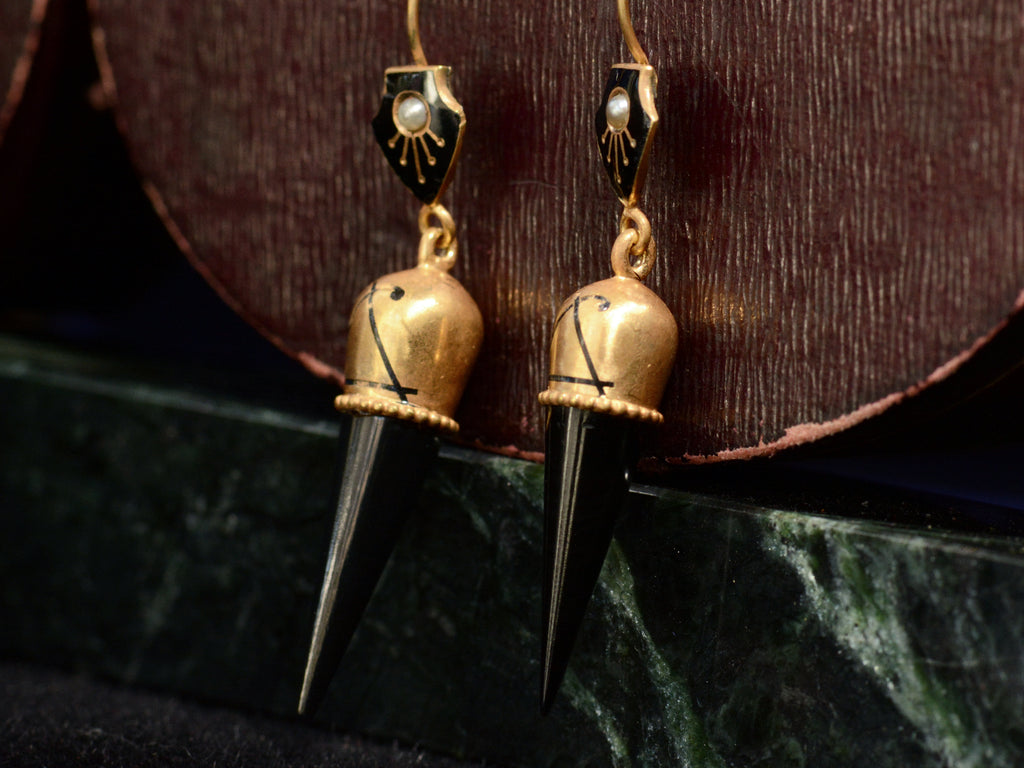 Right angle view of c1880 Black Jet Spike and Yellow Gold Earrings (on dark red and green marble background)