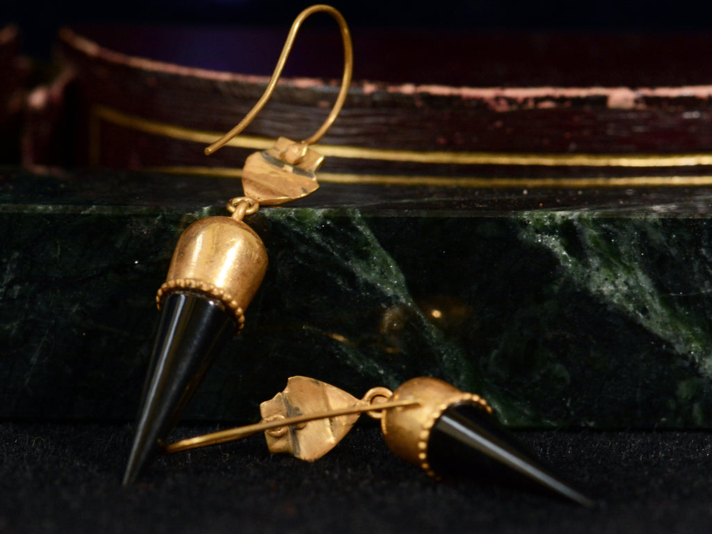 Backside view of c1880 Black Jet Spike and Yellow Gold Earrings (on dark red and green marble background)