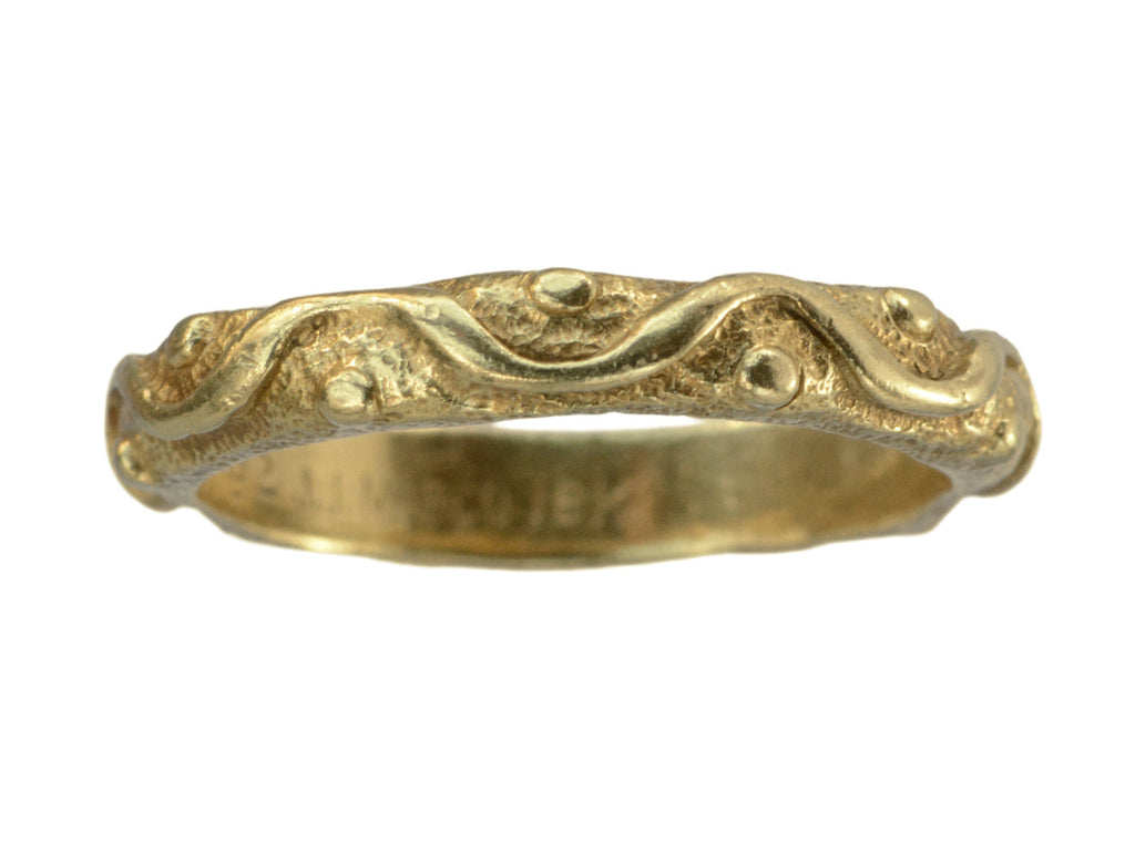 A vintage 18K yellow gold band patterned with a wave and dot pattern in high relief.  Markings inside the ring are faintly visible reading "JJ MARCO 18K." Shown on white background.