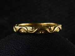 thumbnail of A vintage 18K yellow gold band patterned with a wave and dot pattern in high relief, shown on dark background.