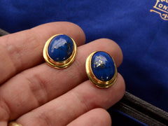 thumbnail of Pair of oval blue lapis lazuli stud earrings in 18k yellow gold, shown on hand