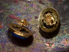 thumbnail of Reverse sides of oval blue lapis lazuli stud earrings in 18k yellow gold, shown on dark background.