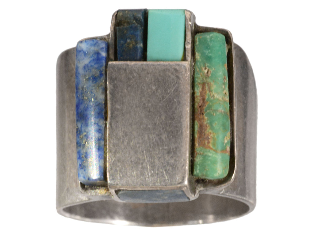 A vintage silver ring with rectangular slabs of lapis and turquoise (shown on white background)