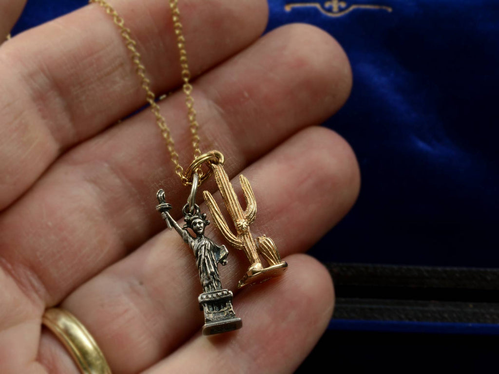 Vintage Silver Statue of Liberty and Gold Cactus Charms Necklace (on hand for scale)