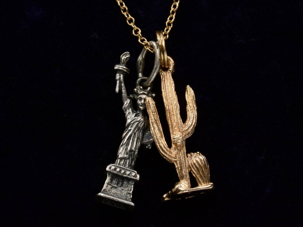 Vintage Silver Statue of Liberty and Gold Cactus Charms Necklace (on black background)