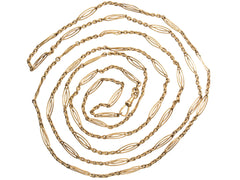 thumbnail of A long filigreed yellow gold plated c1890 chain, shown spiraled on a white background.