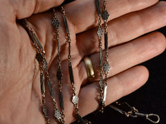 thumbnail of c1890 Long Niello Chain (shown on hand for scale)