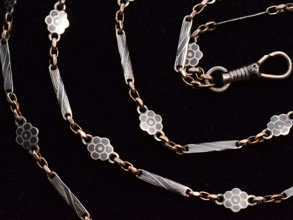 c1890 Long Niello Chain (detail of link decoration, shown on black background)