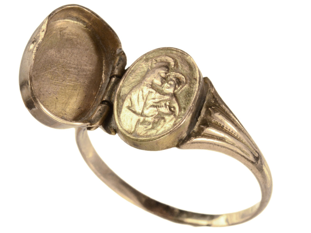 A c1920 antique signet ring shown with the locket open revealing an image of the Madonna and Child. In gold on white background.
