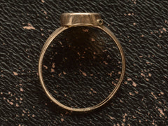thumbnail of Side profile of a c1920 antique signet ring on dark background.
