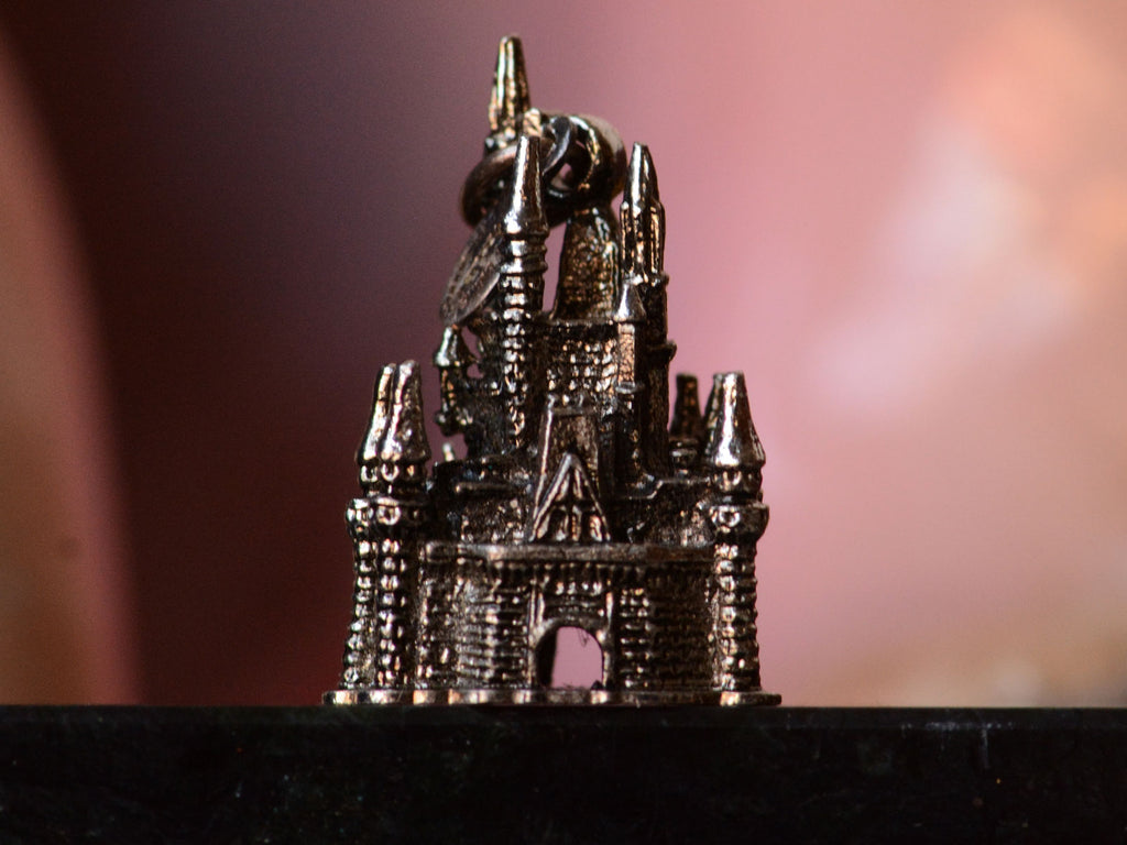 c1990 Silver Disney Castle Charm (on black and pink background) 
