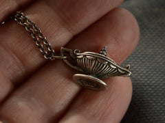 thumbnail of Detail of sterling silver magic lantern pendant hanging from cable chain, shown held in hand. Stamp on bottom reads "BEAU STERLING"