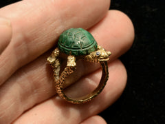 thumbnail of c1970 Malachite Turtle Ring (side profile, shown on hand for scale)