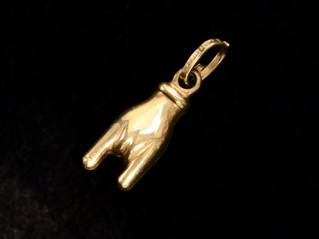 c1980 Gold Mano Cornuto Charm (front side black background)