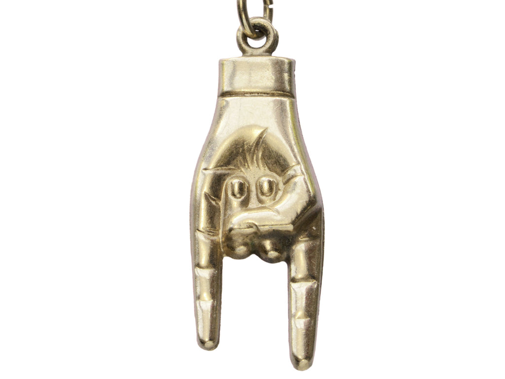 Detail of vintage gold hand pendant gesturing the sign of the horns, on white background.