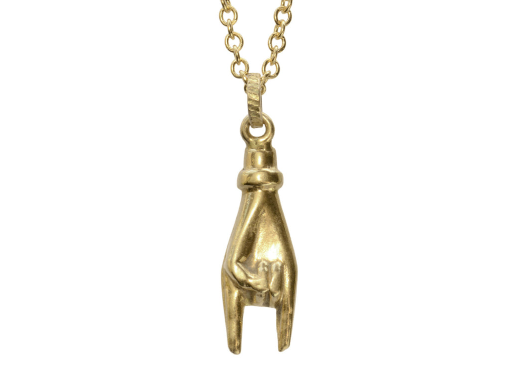 A c1980 yellow gold hand charm gesturing the sign of the horns, shown on white background.
