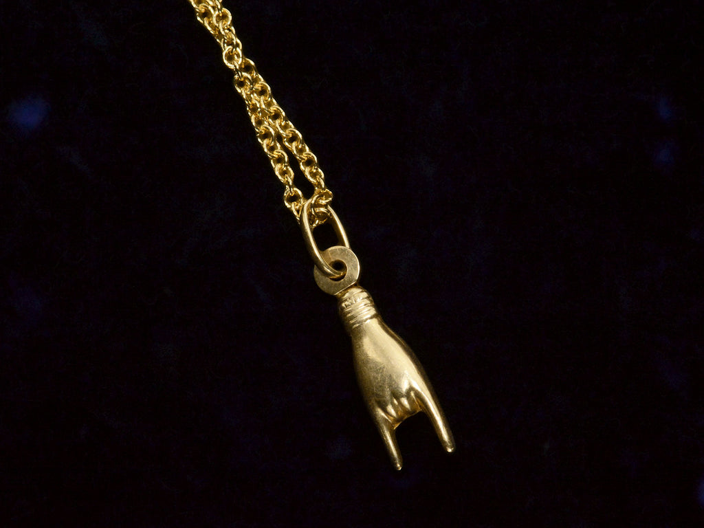 Reverse side of Vintage Yellow Gold Sign of the Horns Hand Pendant on Chain (shown on dark background). 