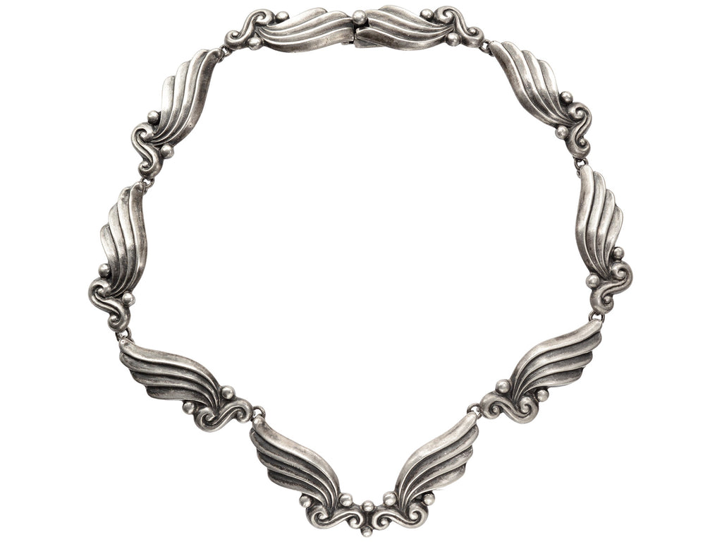 Silver vintage Margot de Taxco necklace with wing-like design on a white background