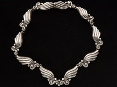 thumbnail of Silver vintage Margot de Taxco necklace with wing-like design on a black background