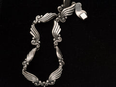 thumbnail of Detail of silver vintage Margot de Taxco necklace with wing-like design on a black background