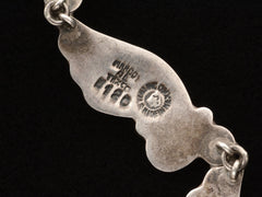 thumbnail of Close up of markings on Margot de Taxco wing necklace with the stamps "MARGOT DE TAXCO 5120" and "STERLING MADE IN MEXICO."