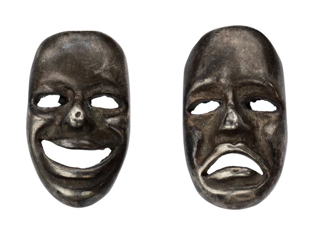 A pair of oxidized silver theatrical mask stud earrings depicting tragedy and comedy. On white background.
