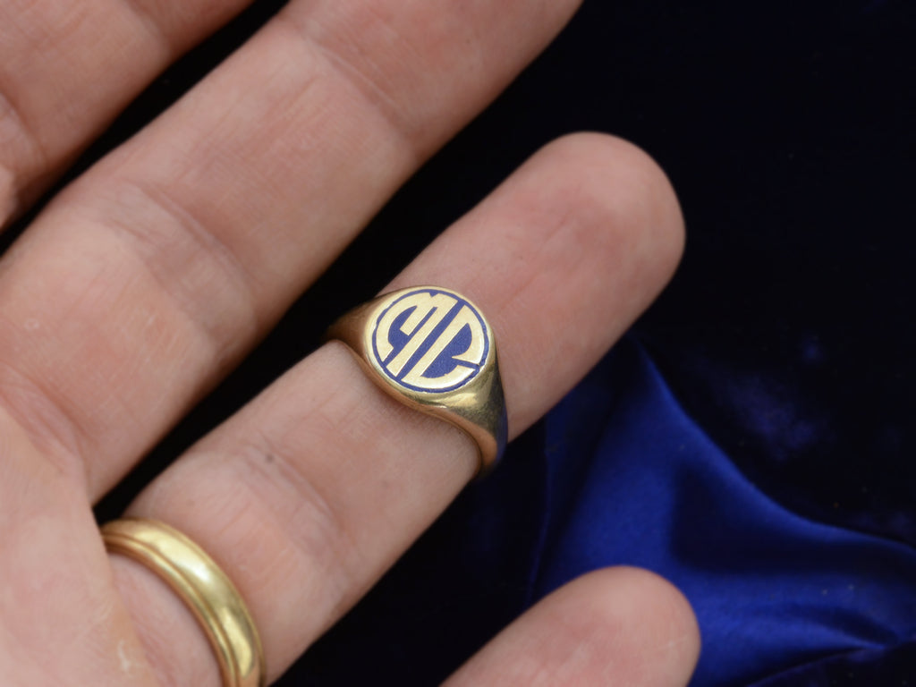 c1920 Round Signet Ring in Yellow Gold with the initials MC in blue enamel, shown on finger for scale