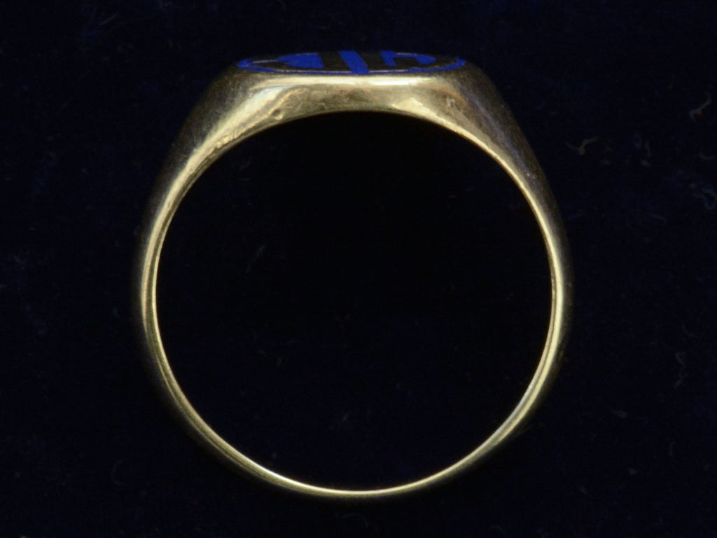 Side profile of c1920 Round Signet Ring in Yellow Gold with the initials MC in blue enamel, shown on black background