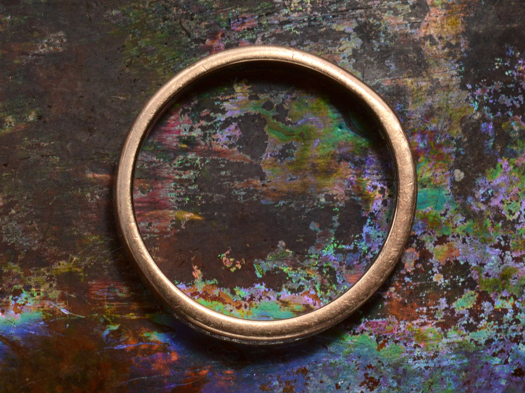 Side view of vintage Men's Diamond Band in Platinum and Rose Gold (shown on dark colorful background)