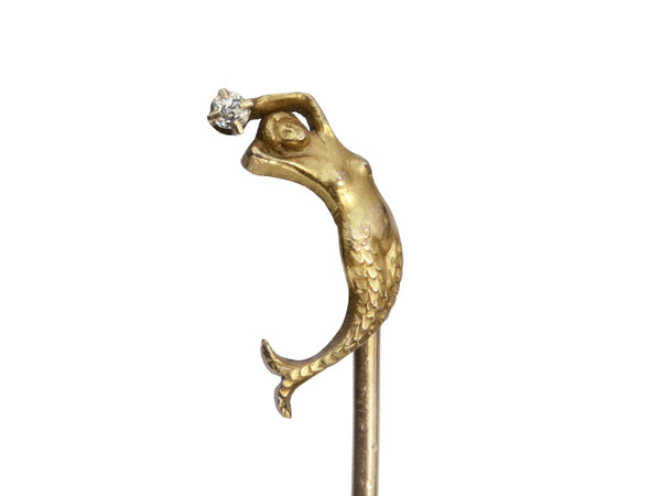 Detail of yellow gold c1890 Mermaid Stick Pin with a diamond, shown on white background.