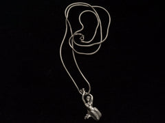 thumbnail of A vintage silver mermaid pendant on snake chain, on black background.
