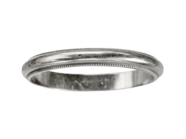 A 14K white gold c1940 wedding band with milgrain edges, shown on white background.