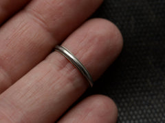 thumbnail of A 14K white gold c1940 wedding band with milgrain edges, shown on finger